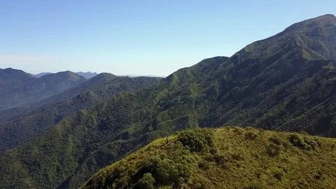 Aerial View. Rotating around a Man on The Summit of a Forest Mountain 库存影片 76964905