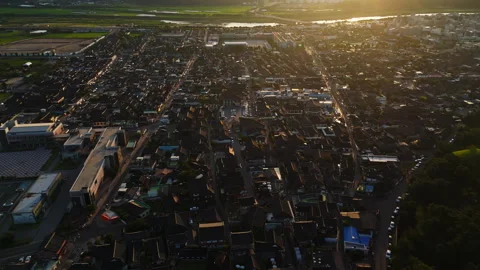 Aerial view rotating over the cityscape of Gyeongju, golden hour in South Korea Stock Footage 336691502