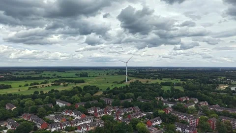 Aerial View of Rotating Wind Turbine Under Dark Clouds in Bremen, Germany Stock Footage 341696515
