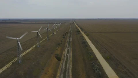 Aerial view rotating windmill and dirt road Stock Footage 118742662