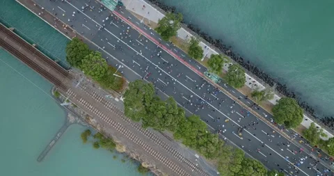 Aerial view of Round the bays fun run along a coastal road in Auckland, New Stock-Footage 303447767