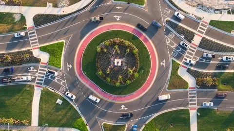 Aerial view of roundabout intersection on American road with moving traffic cars Stock Footage 325403921