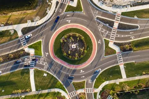 Aerial view of roundabout intersection on American road with moving traffic c Stock Photos