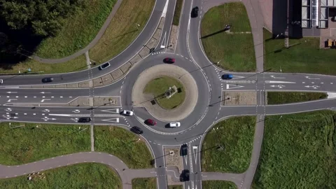 Aerial view of a roundabout at the intersection of two asphalted roads Stock Footage 218578116