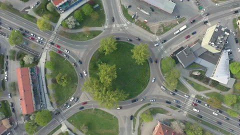 Aerial view of roundabout junction. View from high above, traffic &amp; cars. Stock Footage 130563828