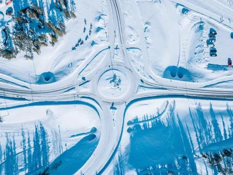 Aerial view of roundabout road intersection with snow winter road with a circ Stock Photos