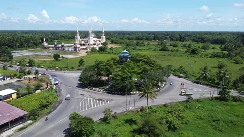 Aerial view of a roundabout with a unique diamond shaped or ketupat buildin.. Stock Footage 276942264