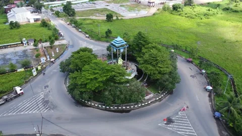 Aerial view of a roundabout with a unique diamond shaped or ketupat buildin.. Stock Footage 276942314