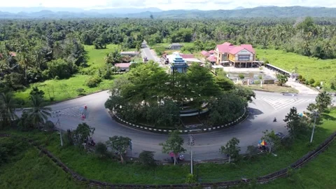 Aerial view of a roundabout with a unique diamond shaped or ketupat buildin.. Stock Footage 276943198
