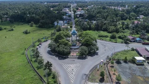 Aerial view of a roundabout with a unique diamond shaped or ketupat buildin.. Stock Footage 276943296