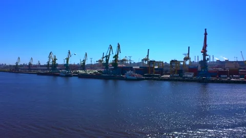 Aerial view of a row of construction or cargo cranes on the river bank Video stock 136151398