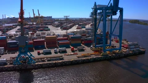 Aerial view of a row of construction or cargo cranes on the river bank Video stock 136153432