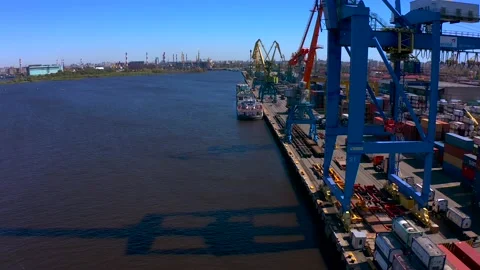 Aerial view of a row of construction or cargo cranes on the river bank Stock Footage 136164313