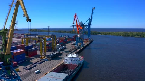Aerial view of a row of construction or cargo cranes on the river bank Video stock 136167610