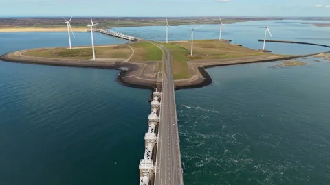 Aerial view of a row of modern offshore wind turbines on a coastal pier. Stock Footage 337590253