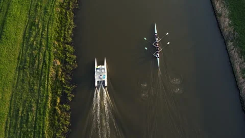 Aerial view of a rowing team training on a river Stock Footage 336364243