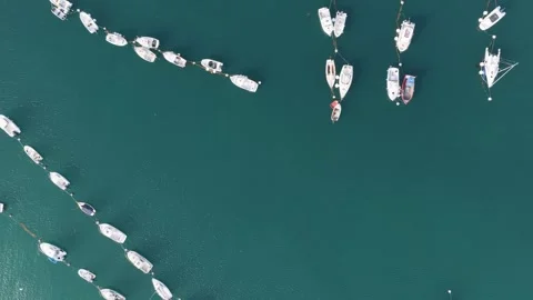 Aerial view of rows of boats and yachts moored in the calm turquoise waters of Stock Footage 346666421