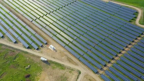Aerial view of rows of solar panels reflecting sunbeams. Video stock 236496240