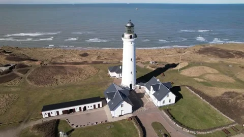 Aerial view of Rubjerg Knude Lighthouse on sand dunes, North Sea coast, Denmark Stock Footage 343539608