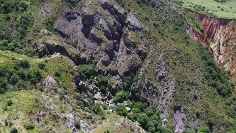 Aerial view of rugged basalt mountainside and eroded red canyon in Kazakstan Stock Footage 337679302