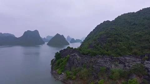 Aerial View of Rugged Cliffs and Calm Waters in Ha Long Bay Stock Footage 280951486