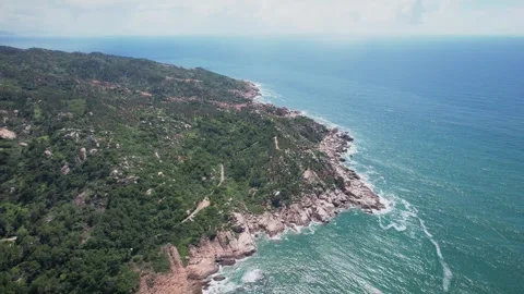 Aerial View of Rugged Coastal Cliffs and Turquoise Ocean Waves on Sunny Day Video stock 342025127