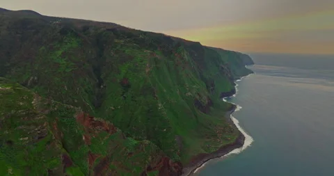 Aerial view of the rugged coastline of cliffs of Achadas da Cruz come into view Stock Footage 271534616