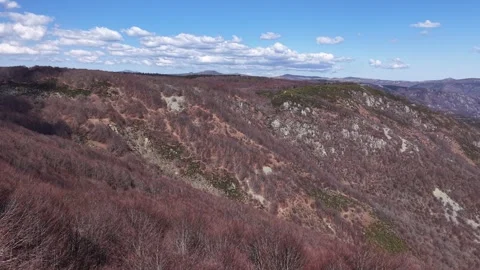 Aerial view of rugged hills with sparse vegetation Video stock 331512956