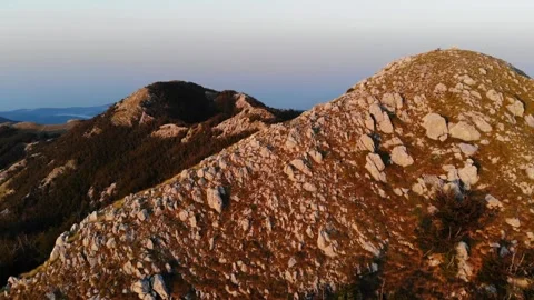 Aerial view of rugged mountain landscape showcasing rocky peaks and sparse Stock-Footage 324749005