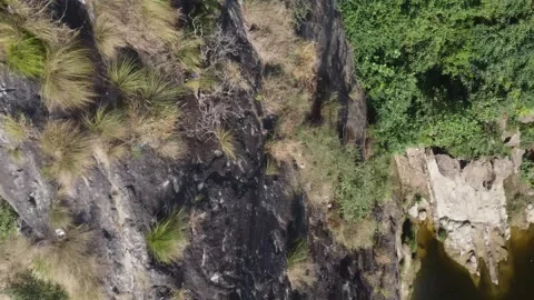 Aerial view of rugged mountain peak with sharp pointed tip Stock Footage 320062745