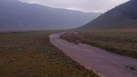 Aerial view of rugged mountains and winding road in Bromo, East Java, Indonesia. Stock Footage 279736604