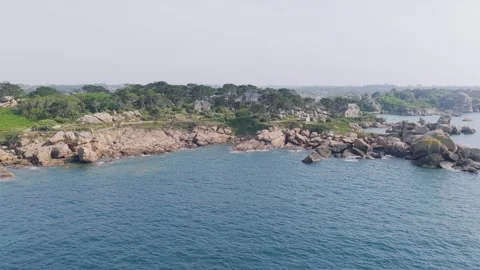 Aerial view of the rugged pink granite coastline along the Sentier des Douaniers Stock Footage 346670950