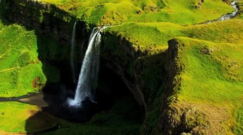 Aerial View of Rugged Ridges &amp; Cascading Meltwater Waterfalls, Iceland Stock Footage 8686301