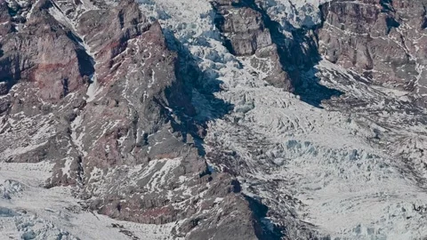 Aerial view of rugged, snow-dusted volcanic ridges reveals the dramatic texture Video stock 313027187