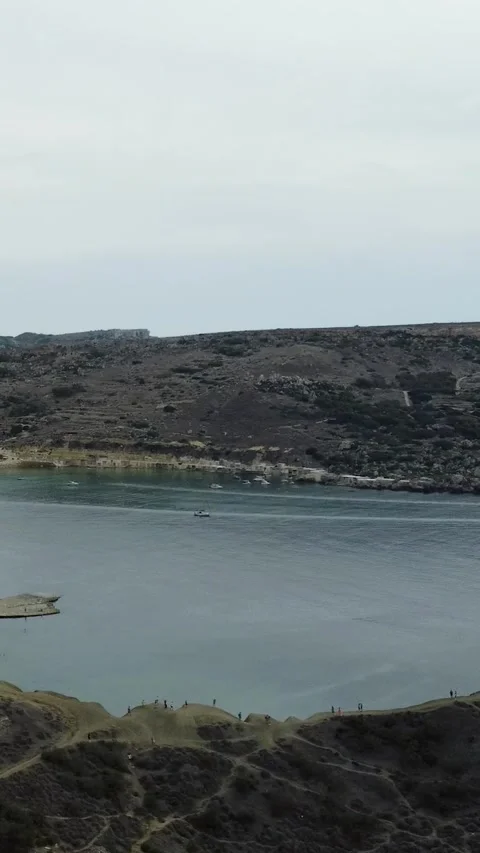 Aerial view of rugged white limestone cliffs and turquoise Mediterranean se.. Video stock 327034954