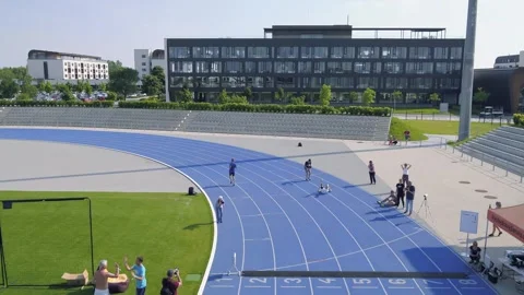 Aerial view of runner practicing on race track in stadium, Stock Footage 247241323