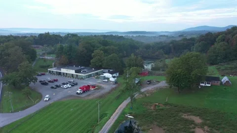 Aerial view of rural elementary school in the West Virginia mountains on a crisp Stock Footage 163964964