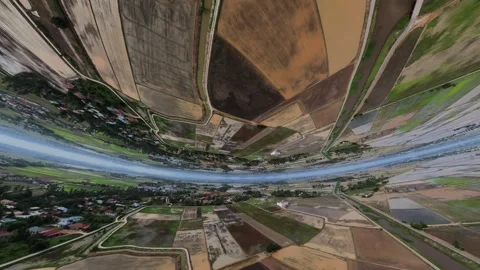 Aerial view of rural farmland with patchwork fields and roads in landscape Видео 345398549