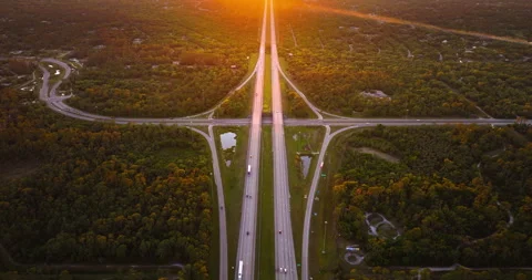 Aerial view of rural freeway junction with fast moving cars and trucks at sunset Stock Footage 314347240