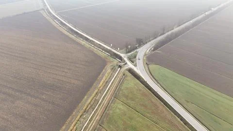 Aerial view of a rural intersection with fields and a road curving through .. Stock Photos