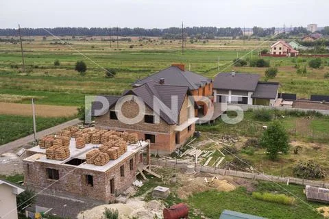 Aerial view of rural land for development in green field. New not finished br Stock Photos