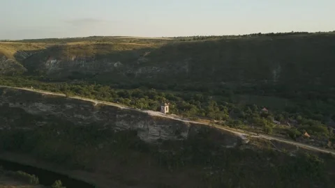 Aerial view of a rural landscape in Eastern Europe, showcasing a winding road, a Stock Footage 332725621