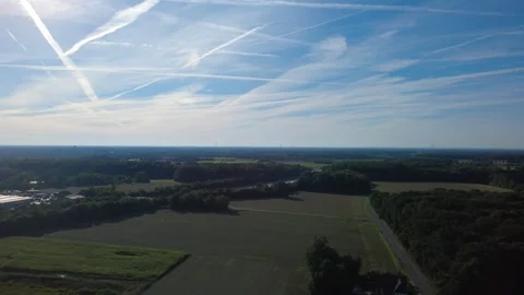 Aerial view of rural landscape with fields and forest under blue sky Stock-Footage 327328222