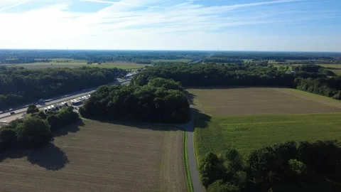 Aerial view of rural landscape with fields and forest under blue sky Stock Footage 327328230