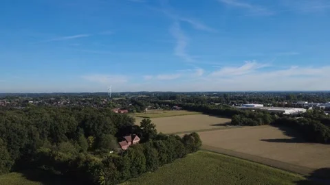 Aerial view of rural landscape with fields and forest under blue sky Stock Footage 327328362