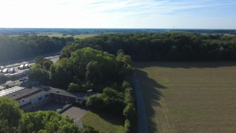 Aerial view of rural landscape with fields and forest under blue sky Stock Footage 327328390