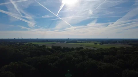 Aerial view of rural landscape with fields and forest under blue sky Stock Footage 327328407