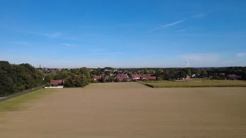 Aerial view of rural landscape with fields and forest under blue sky Stock Footage 327328462