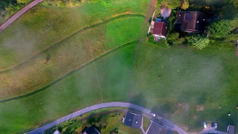 Aerial view of a rural landscape with patchwork fields of green, gold, and Video stock 266139682