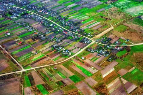 Aerial view of rural landscape with patchwork agricultural fields, tiny hou.. Stock Photos